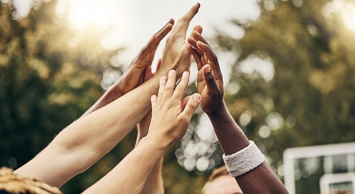 Hands high-five in a team huddle