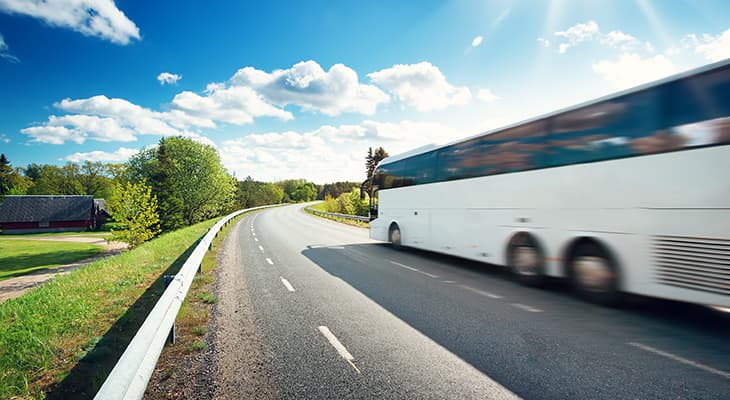 White charter bus on a rural highway