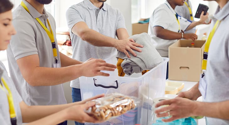 Volunteer pack boxes with clothes and food for charity