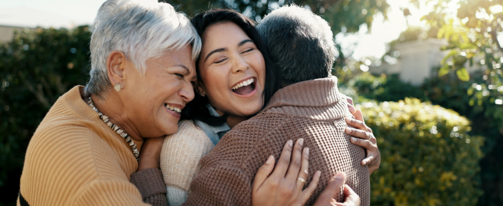 A family hugging and laughing together.